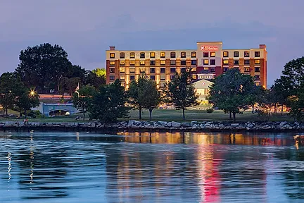 A hotel reflecting on the water at twilight, a comfortable stay for runners